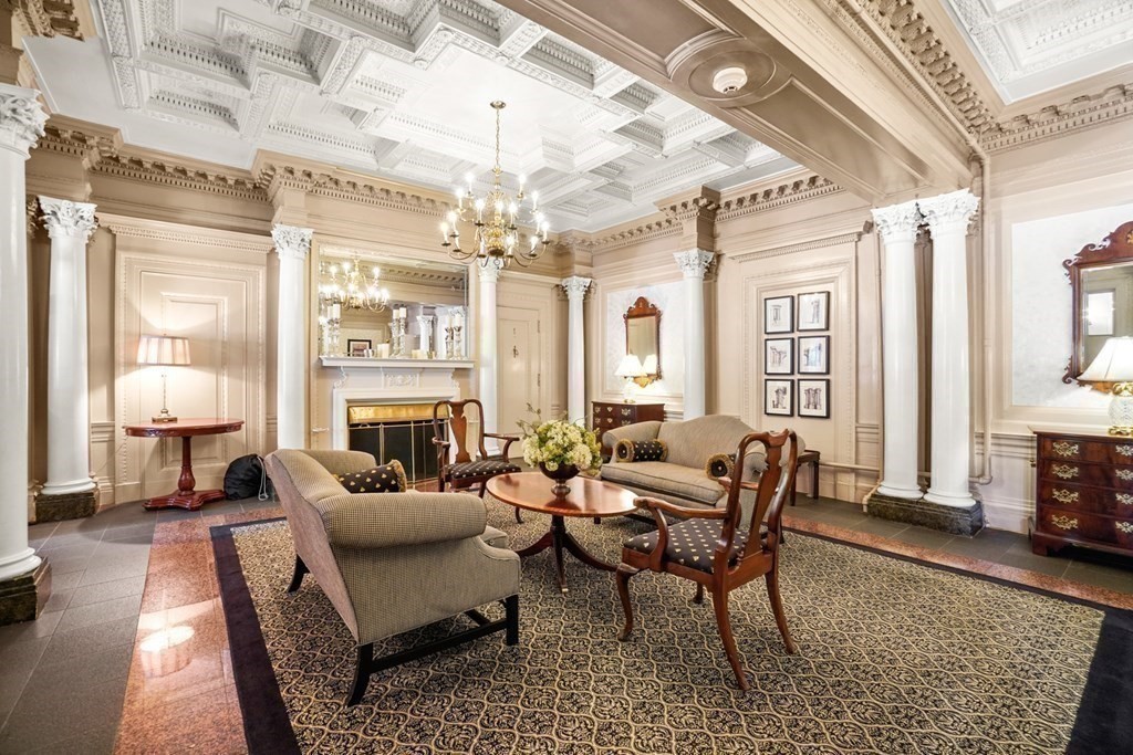 333 Commonwealth Avenue, Unit PH22 Boston, MA 02115 - Photo 38 of 42 a living room with furniture a fireplace and a chandelier