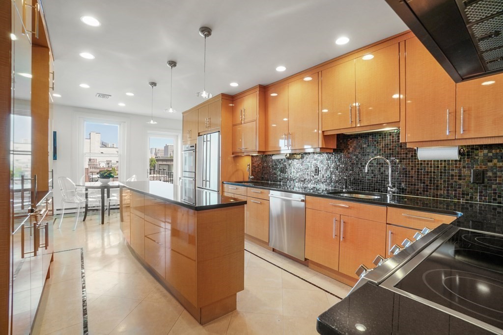 333 Commonwealth Avenue, Unit PH22 Boston, MA 02115 - Photo 4 of 42 a kitchen with stainless steel appliances granite countertop a sink and a refrigerator