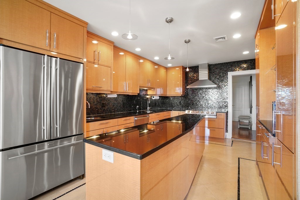 333 Commonwealth Avenue, Unit PH22 Boston, MA 02115 - Photo 5 of 42 a kitchen with stainless steel appliances granite countertop a refrigerator a sink and a stove