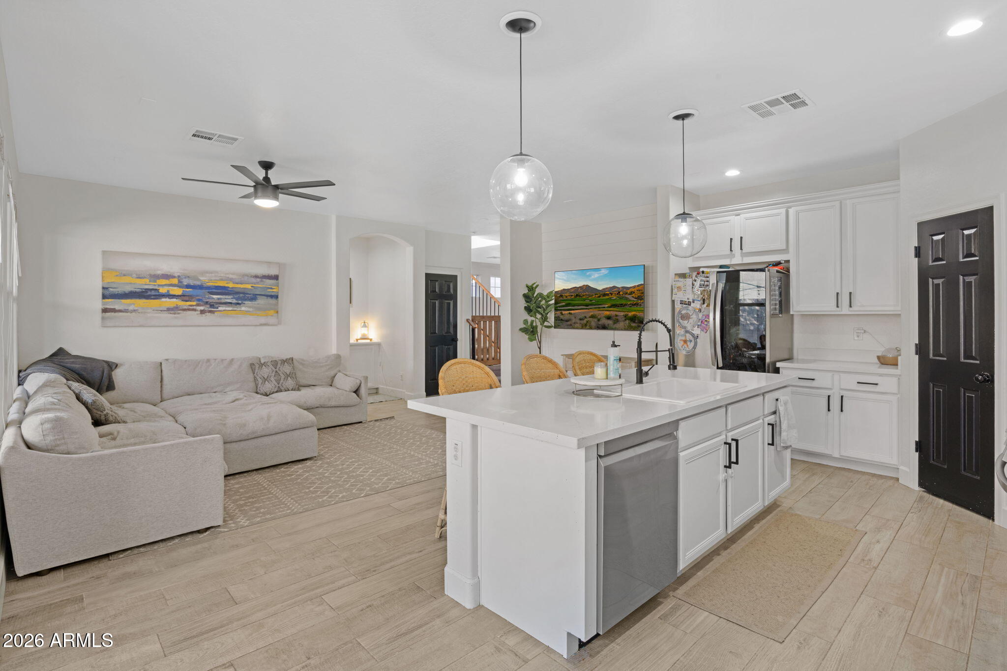 3458 East Robin Lane Gilbert, AZ 85296 - Photo 12 of 32 a kitchen with white cabinets and stainless steel appliances