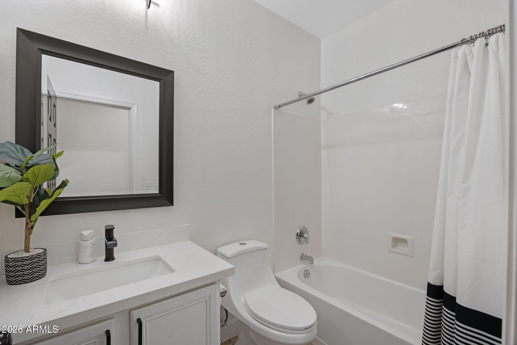 3458 East Robin Lane Gilbert, AZ 85296 - Photo 15 of 32 a bathroom with a granite countertop sink toilet a mirror and shower
