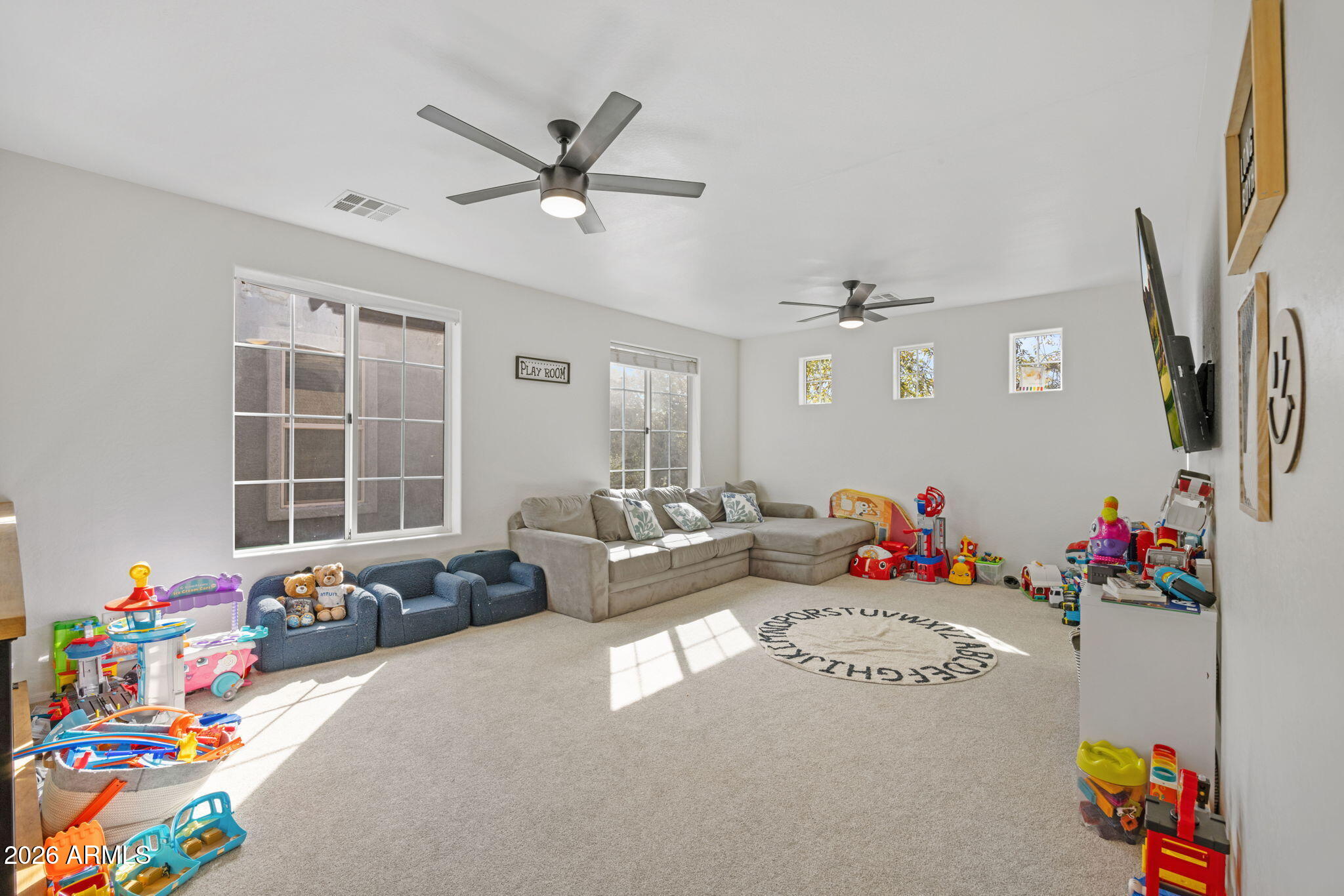 3458 East Robin Lane Gilbert, AZ 85296 - Photo 16 of 32 a living room with furniture and a flat screen tv