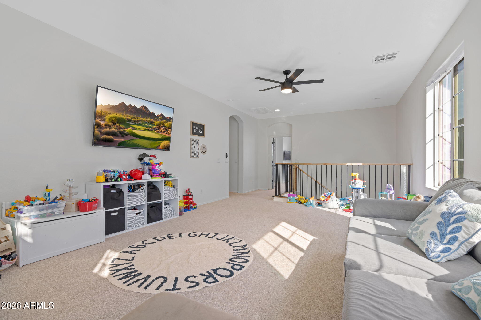 3458 East Robin Lane Gilbert, AZ 85296 - Photo 17 of 32 a bed room with furniture and a flat screen tv