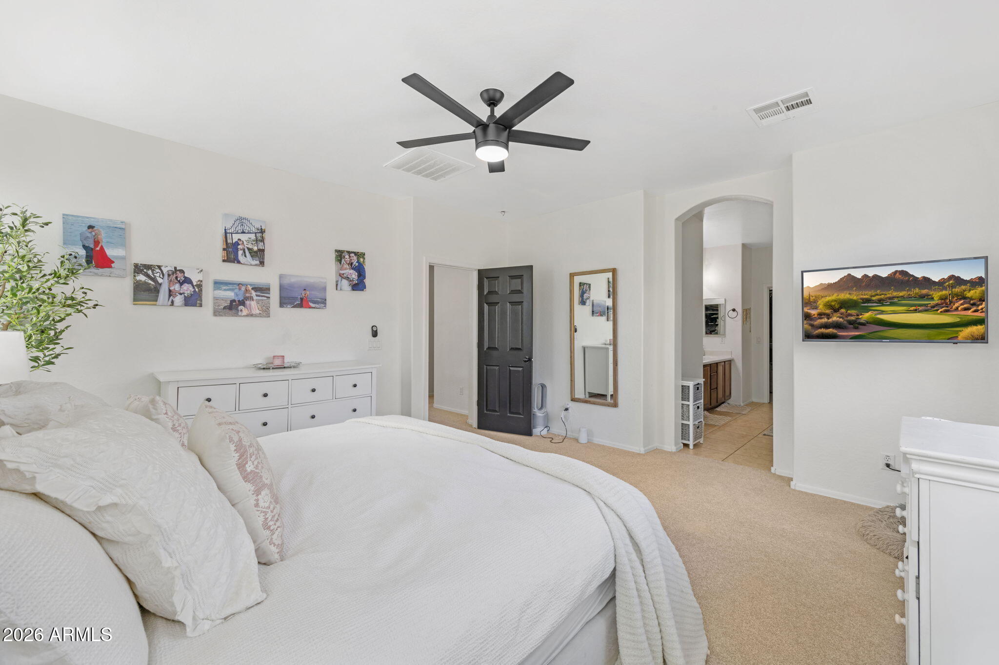 3458 East Robin Lane Gilbert, AZ 85296 - Photo 20 of 32 a bedroom with a bed and ceiling fan