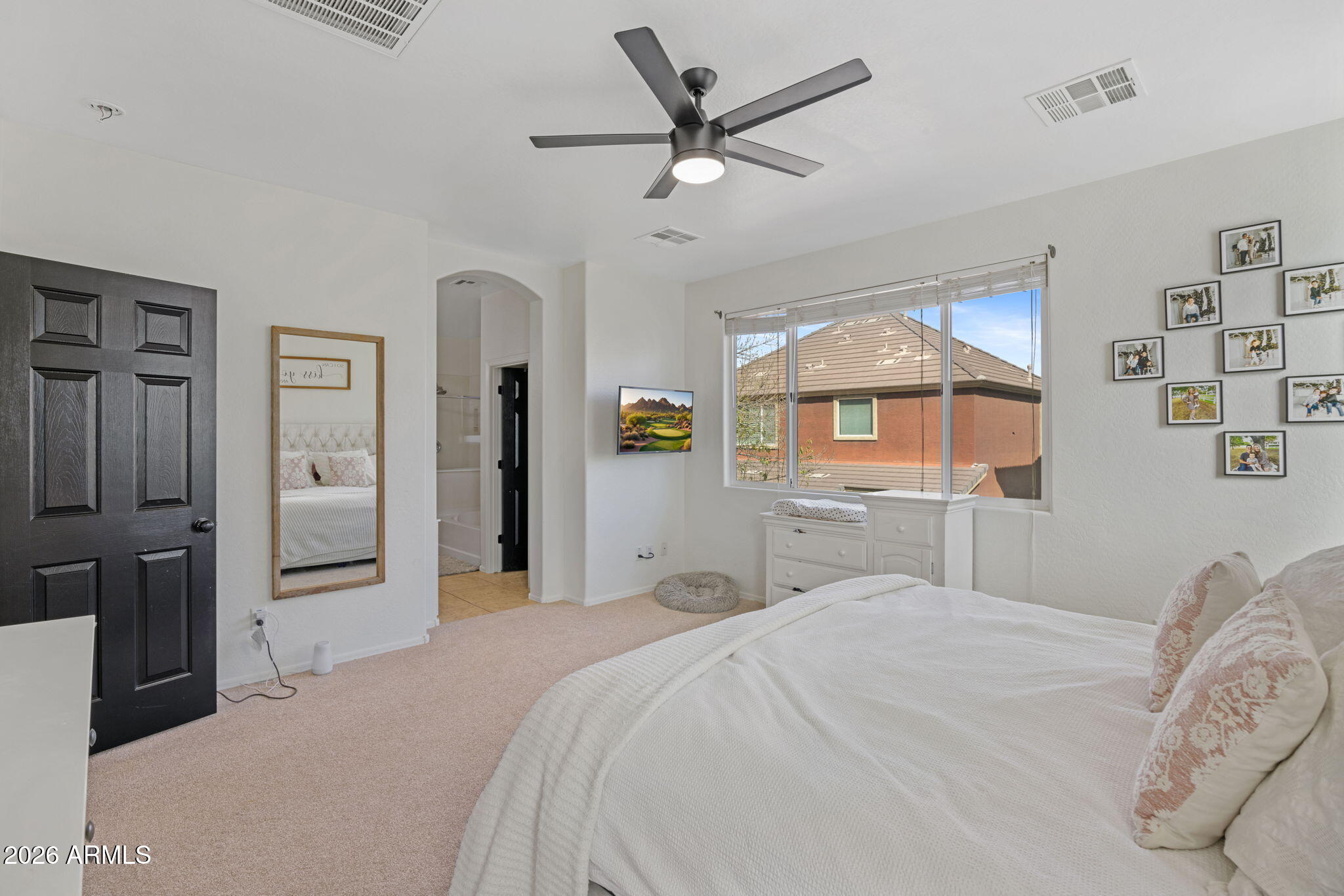 3458 East Robin Lane Gilbert, AZ 85296 - Photo 21 of 32 a bedroom with a large bed and a chandelier