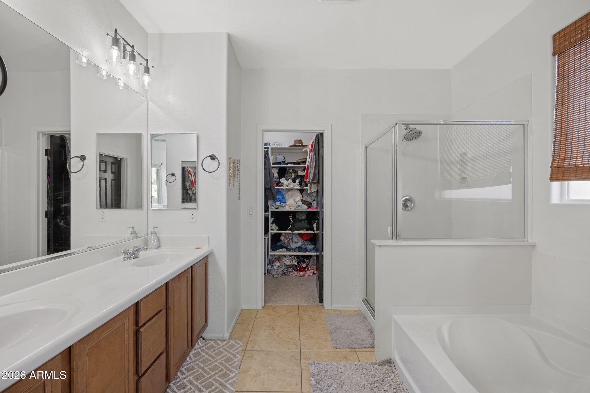 3458 East Robin Lane Gilbert, AZ 85296 - Photo 23 of 32 a bathroom with a tub sink and a mirror