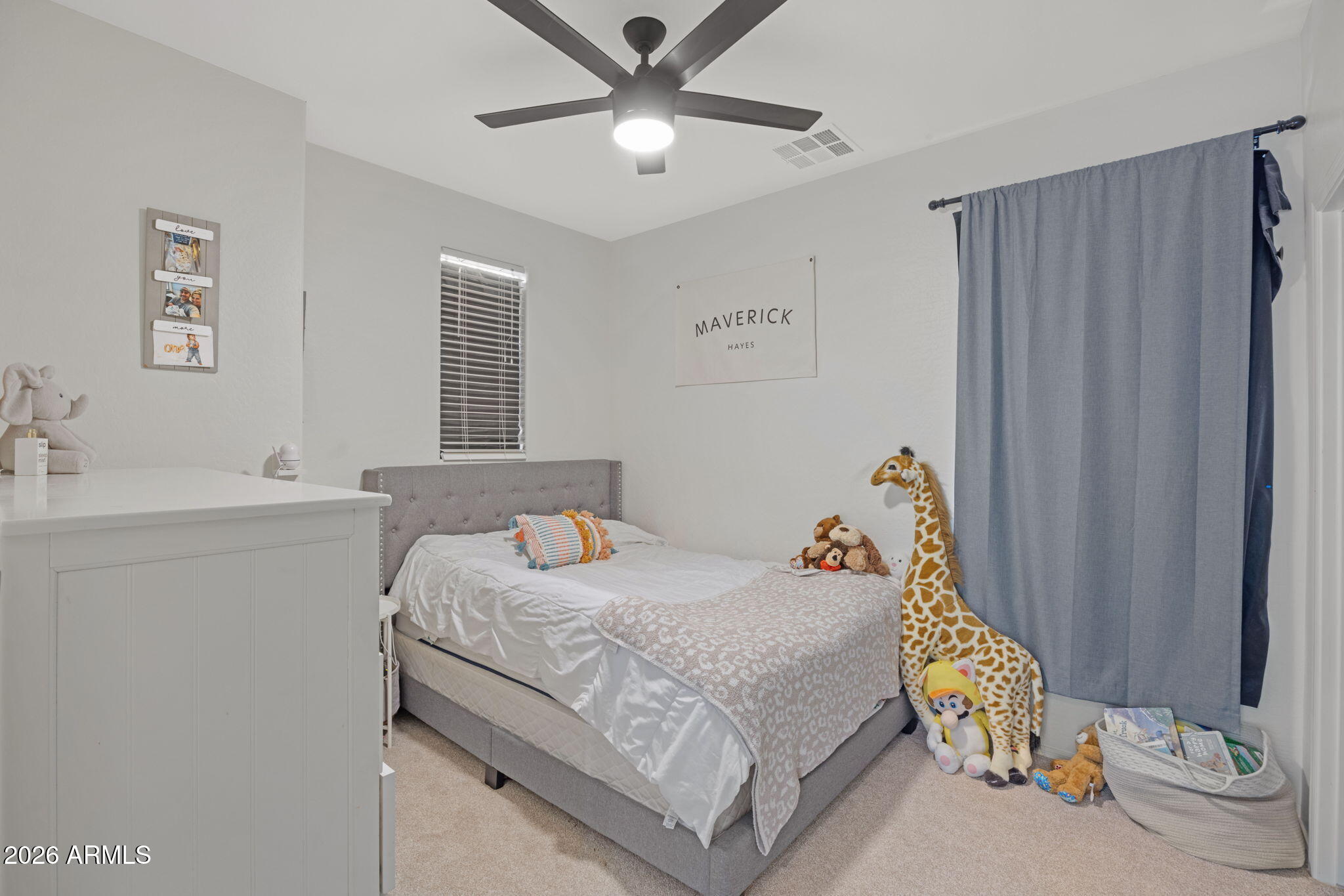 3458 East Robin Lane Gilbert, AZ 85296 - Photo 24 of 32 a bedroom with a bed and a chandelier