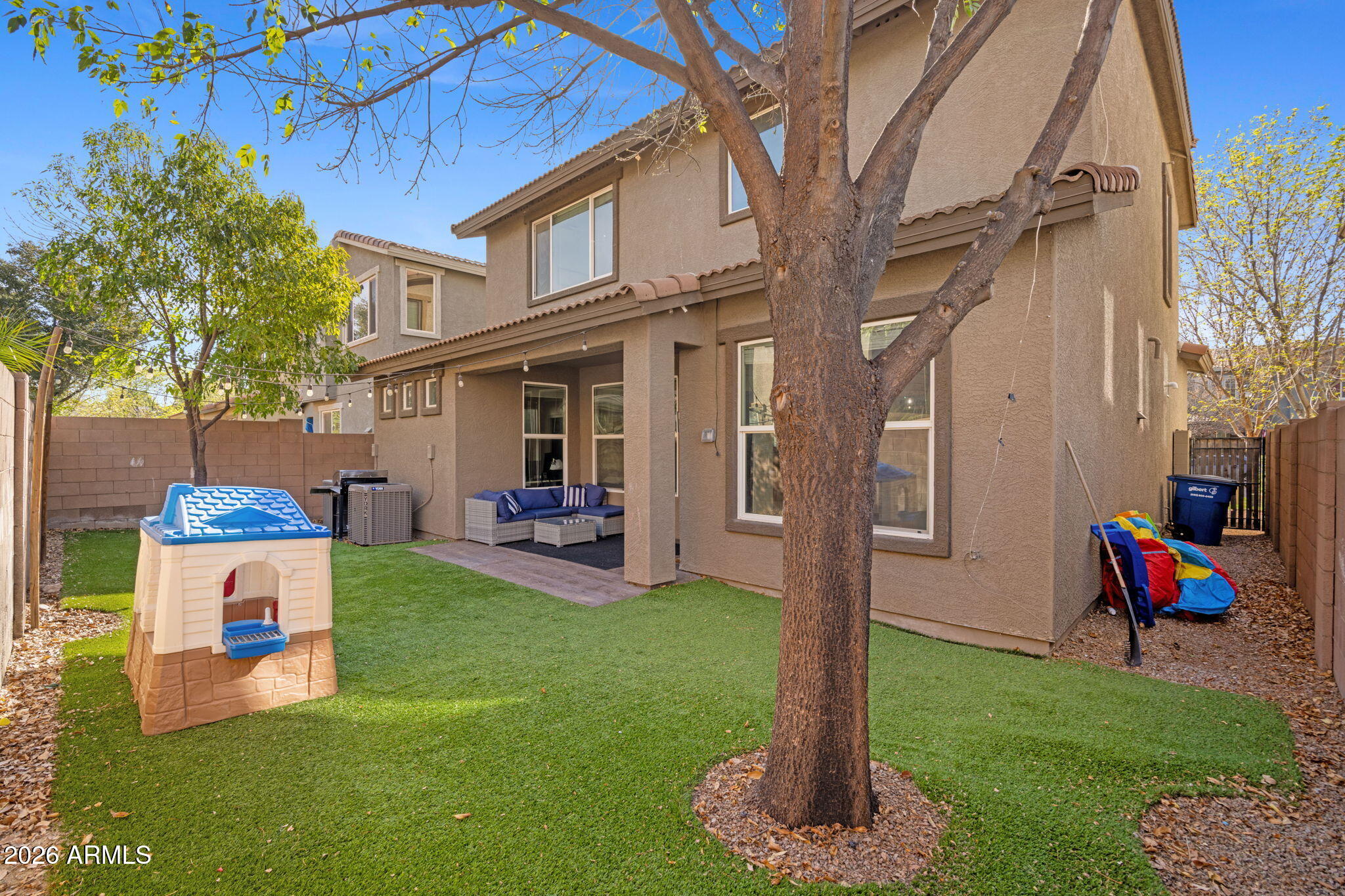 3458 East Robin Lane Gilbert, AZ 85296 - Photo 29 of 32 a front view of a house with a yard table and chairs