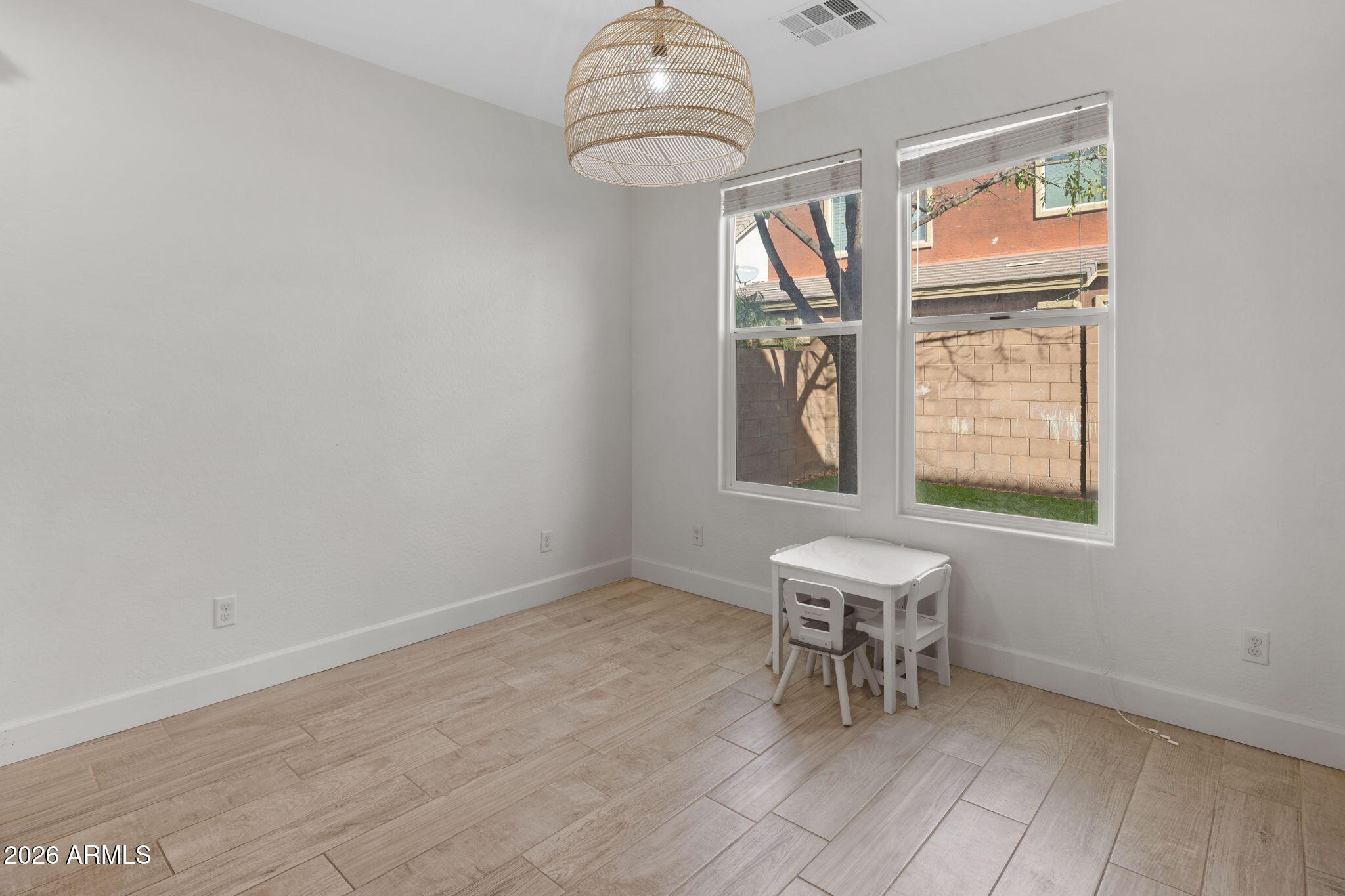 3458 East Robin Lane Gilbert, AZ 85296 - Photo 9 of 32 an empty room with windows and fan