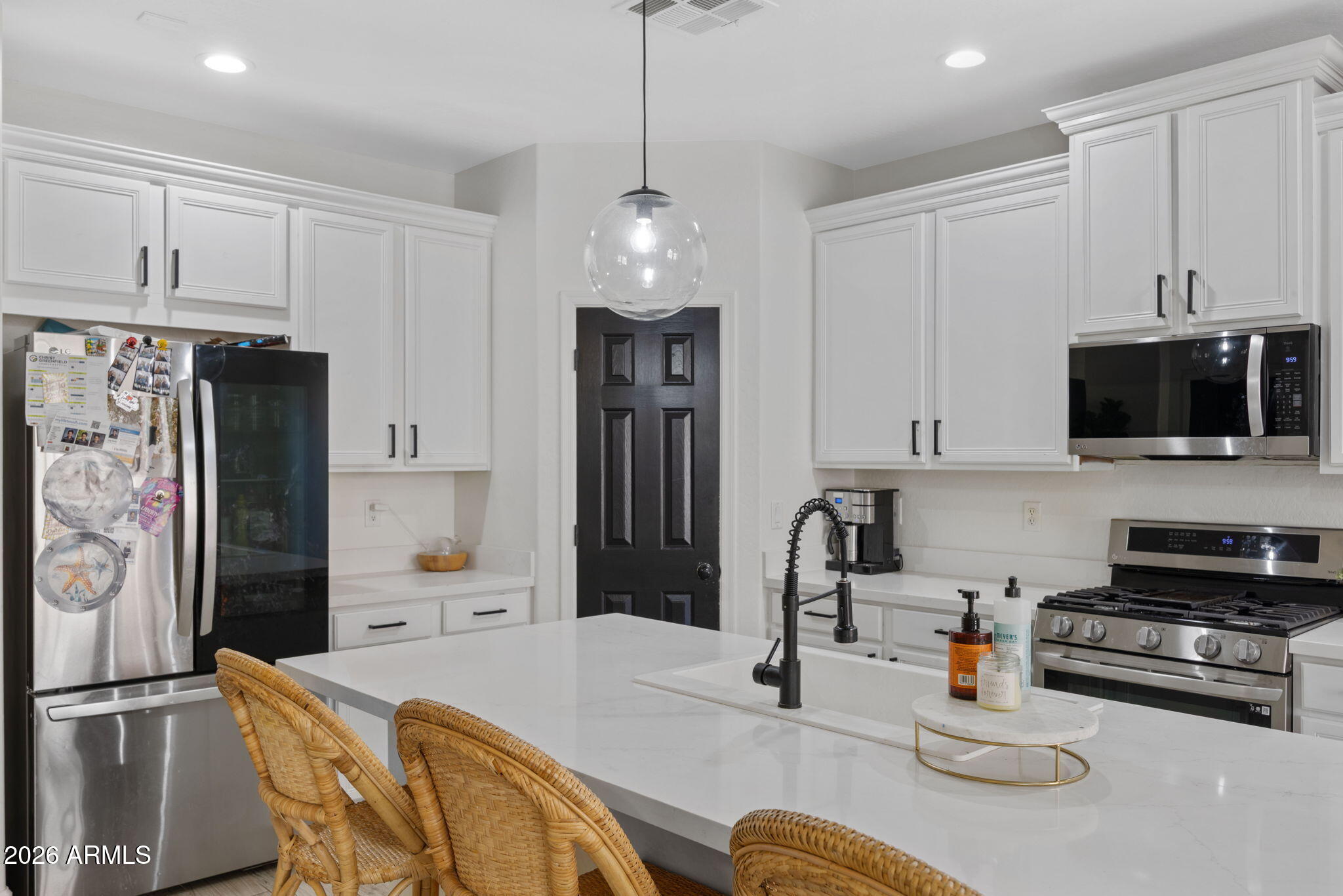3458 East Robin Lane Gilbert, AZ 85296 - Photo 10 of 32 a kitchen with stainless steel appliances granite countertop a sink and a refrigerator