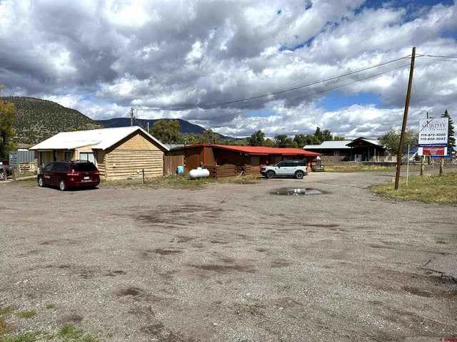 a view of outdoor space with lots of swings and slides