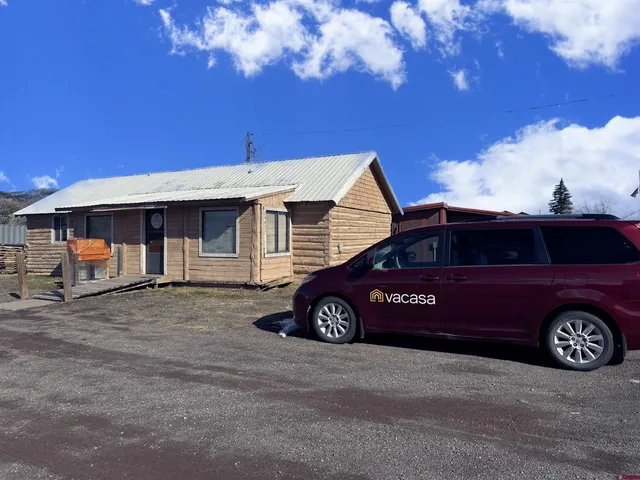 a front view of a house with parking space