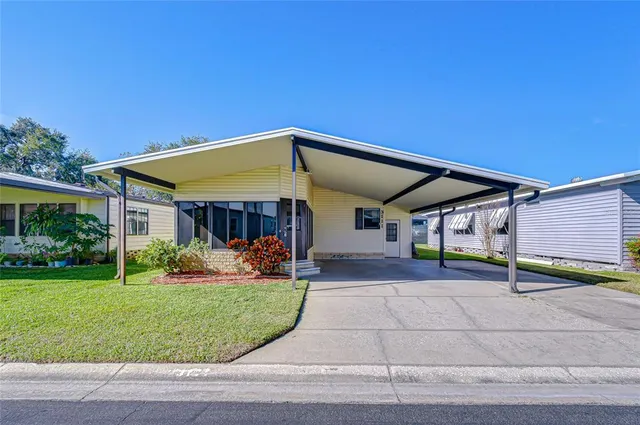 a view of a house with backyard and porch