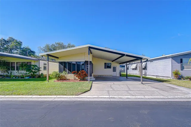 a view of a house with a garden and pathway