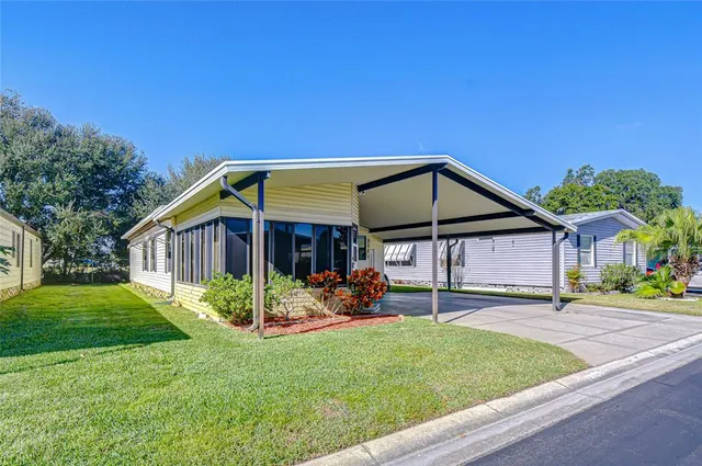 a view of a house with backyard and sitting area