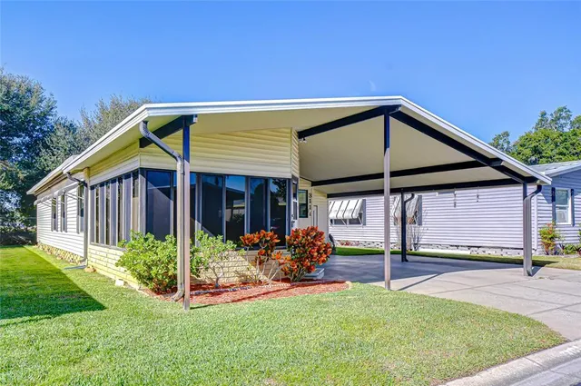 a view of a house with backyard porch and sitting area