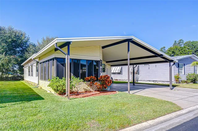 a view of a house with backyard and sitting area