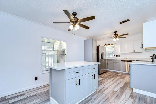 a kitchen with a cabinets a sink and wooden floor