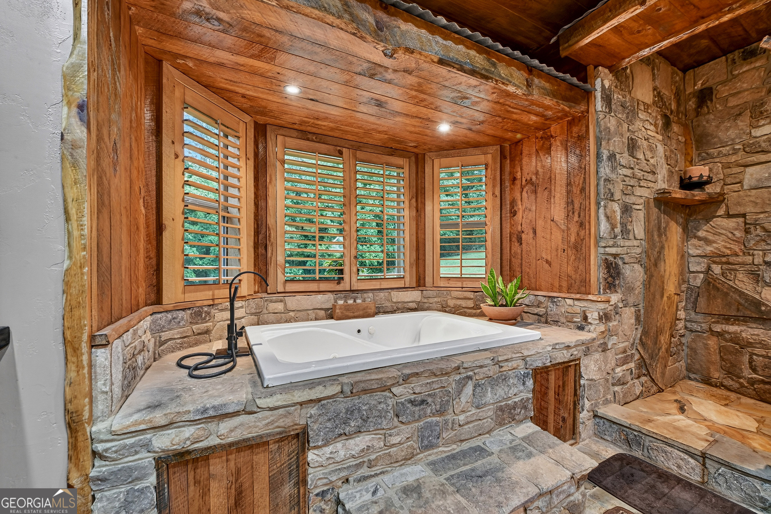 785 Wehunt Road Epworth, GA 30541 - Photo 27 of 73 a bath tub sitting in a bathroom next to a window