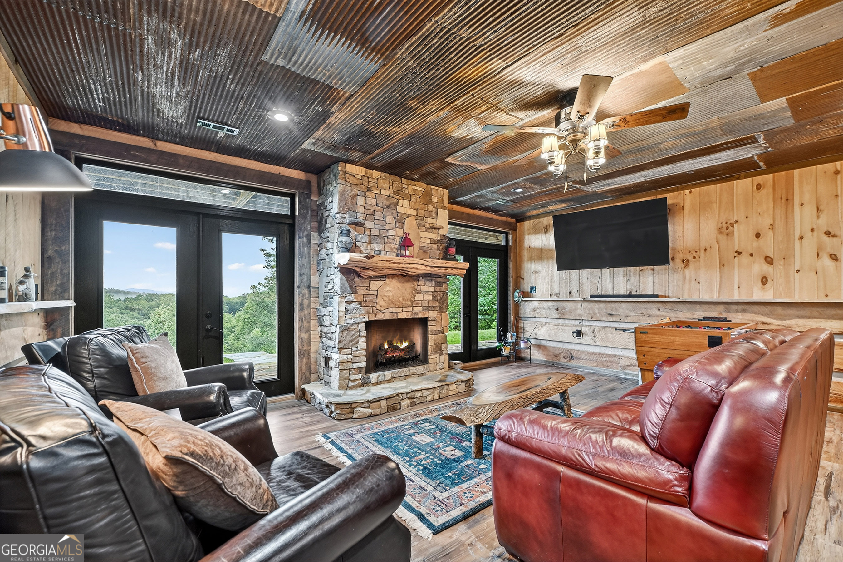 785 Wehunt Road Epworth, GA 30541 - Photo 35 of 73 a living room with furniture a fireplace and a flat screen tv