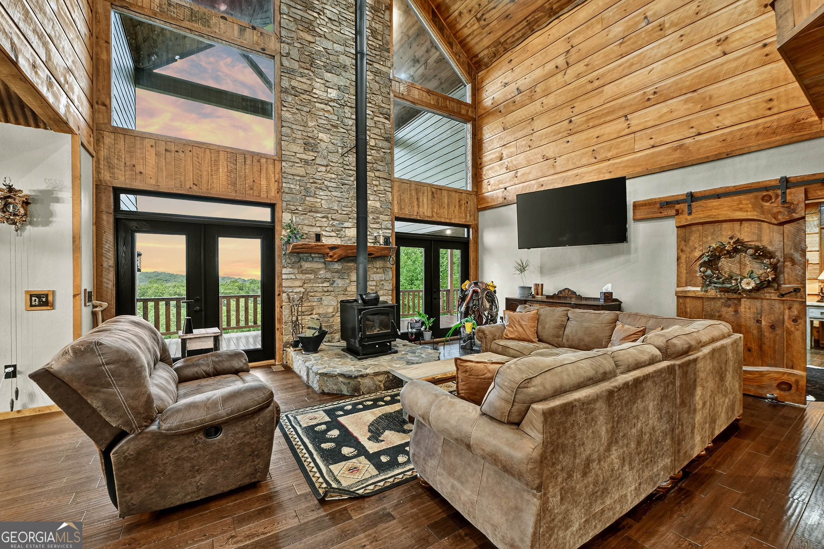 785 Wehunt Road Epworth, GA 30541 - Photo 5 of 73 a living room with furniture a flat screen tv and a large window