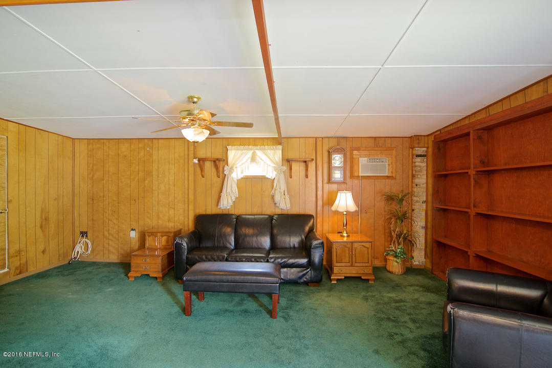 10637 Tulsa Road Jacksonville, FL 32218 - Photo 3 of 22 a living room with furniture and a chandelier