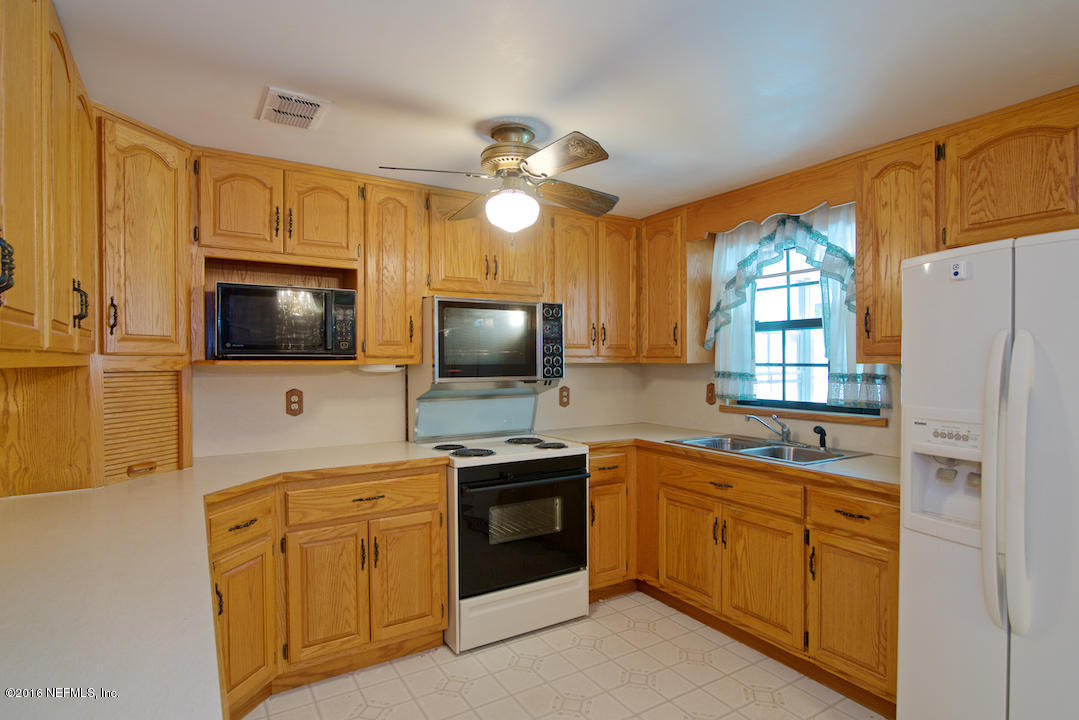 10637 Tulsa Road Jacksonville, FL 32218 - Photo 8 of 22 a kitchen with cabinets stainless steel appliances and wooden floor