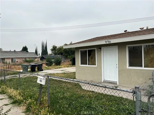 a view of a house with a yard and sitting area