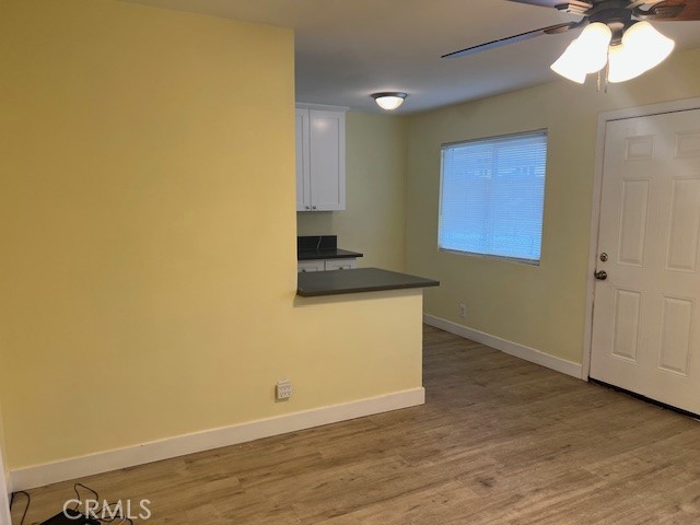 996 North Crescent Avenue San Bernardino, CA 92410 - Photo 5 of 10 a view of an empty room with wooden floor and a window