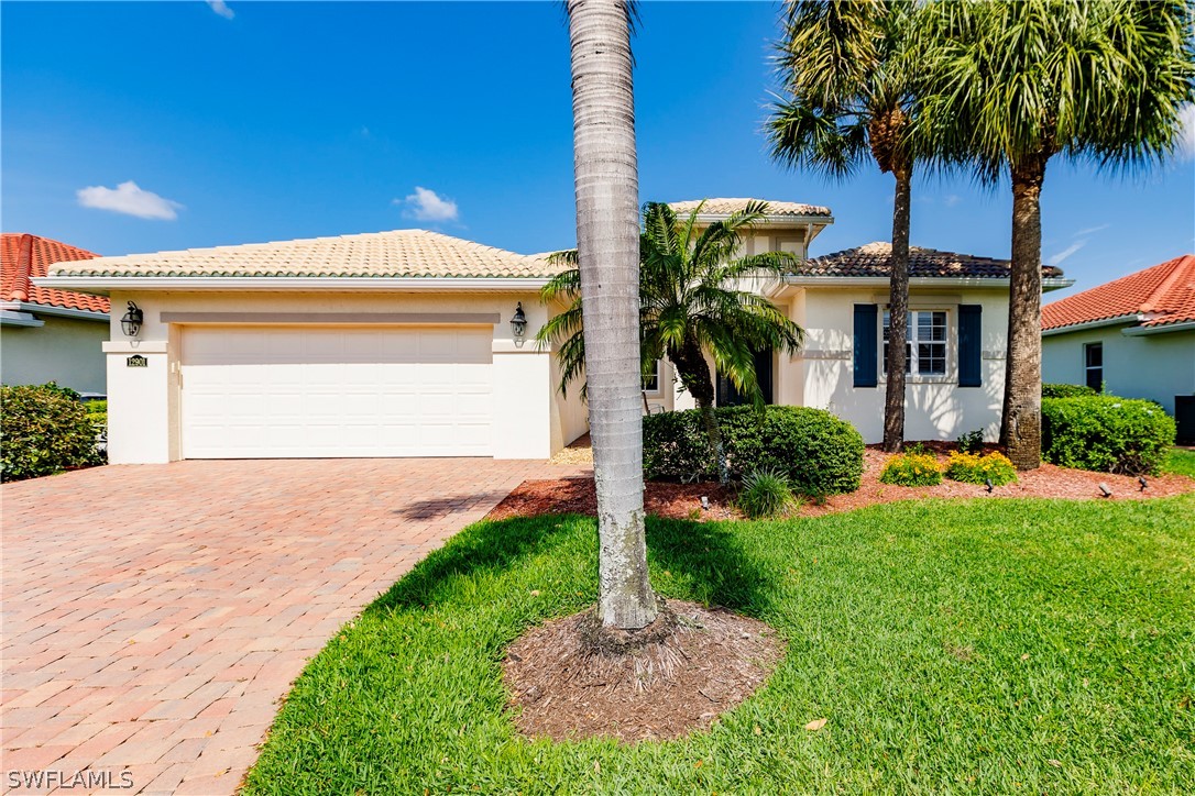 12901 Timber Ridge Drive Fort Myers, FL 33913 - Photo 2 of 49 a front view of house with yard and outdoor seating