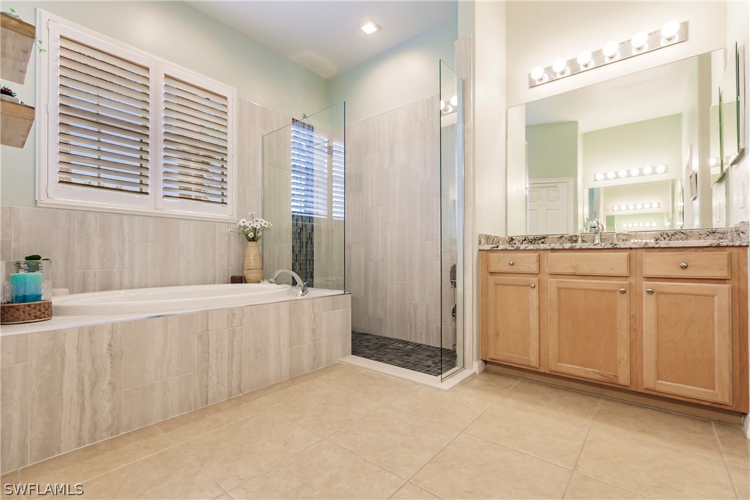 12901 Timber Ridge Drive Fort Myers, FL 33913 - Photo 27 of 49 a spacious bathroom with a granite countertop sink and a bathtub
