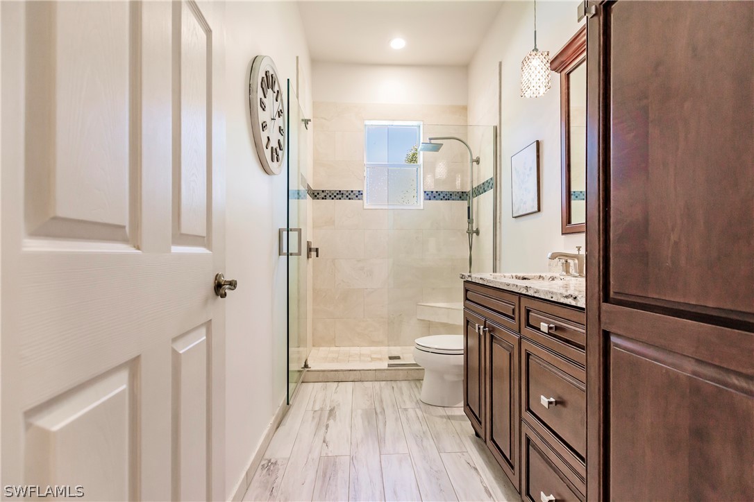12901 Timber Ridge Drive Fort Myers, FL 33913 - Photo 30 of 49 a bathroom with a sink a toilet and shower