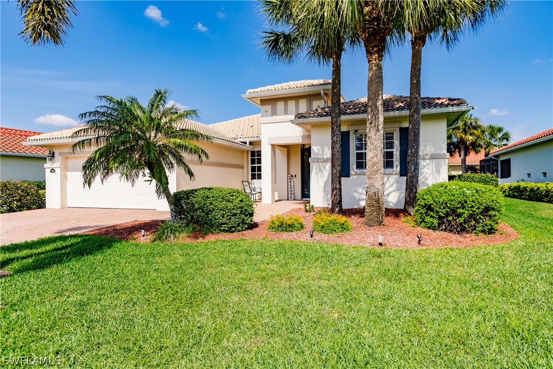 12901 Timber Ridge Drive Fort Myers, FL 33913 - Photo 3 of 49 front view of a house with a yard and palm trees