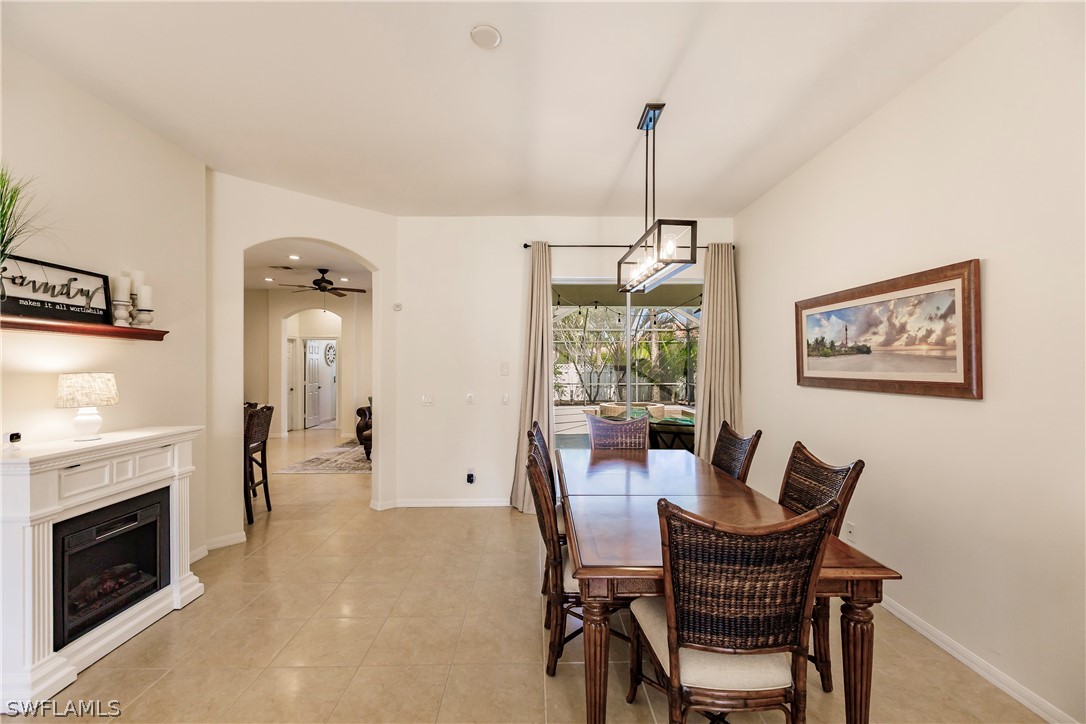 12901 Timber Ridge Drive Fort Myers, FL 33913 - Photo 8 of 49 a dining room with furniture a fireplace and wooden floor