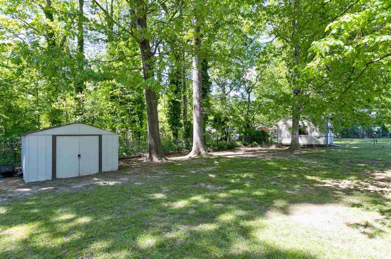 3417 Apache Drive Raleigh, NC 27609 - Photo 25 of 25 a backyard of a house with large trees and plants