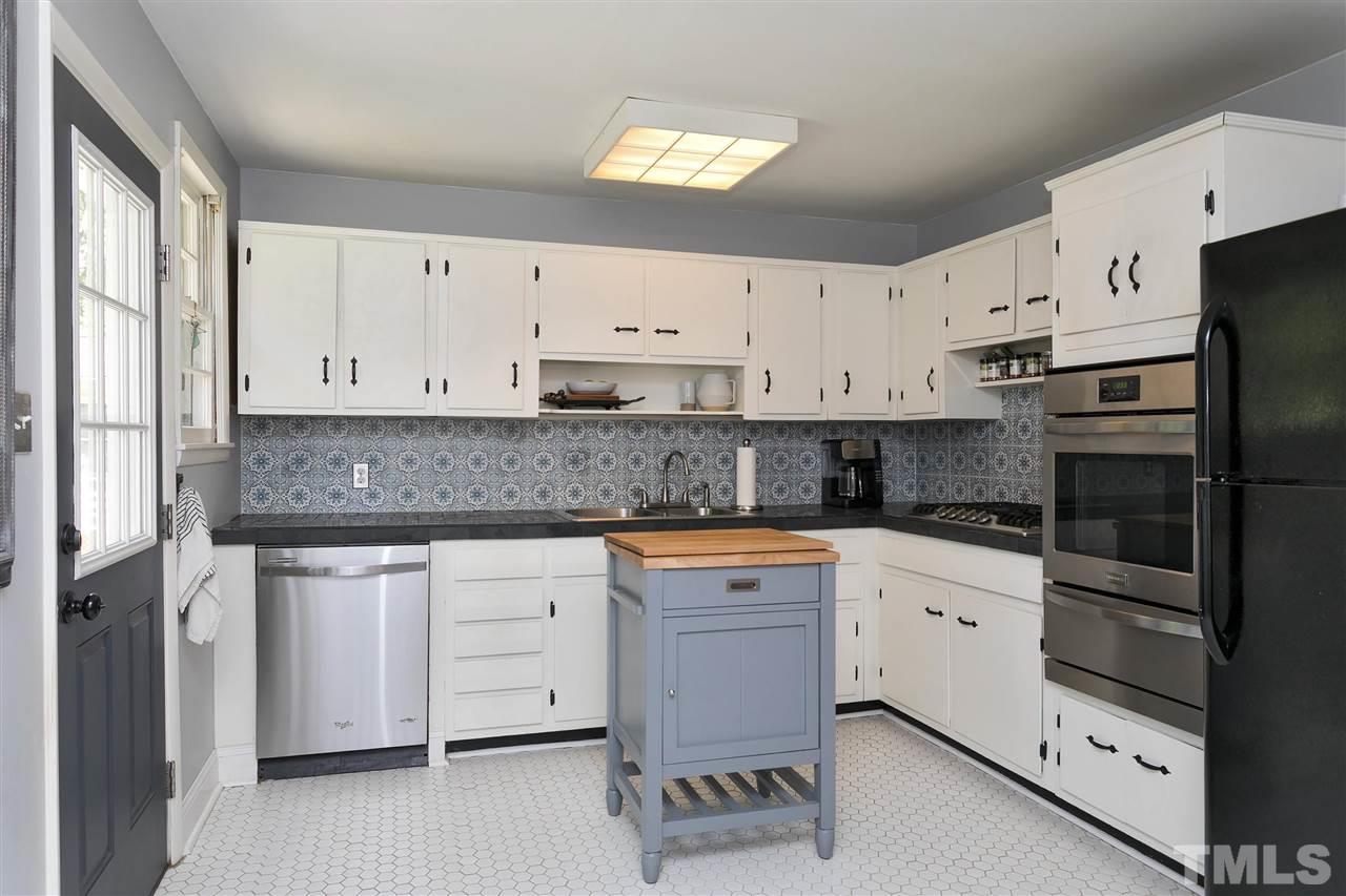 3417 Apache Drive Raleigh, NC 27609 - Photo 6 of 25 a kitchen with granite countertop white cabinets and white appliances