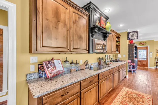 a view of a kitchen area with furniture and wooden floor