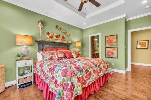 a bedroom with bed and wooden floor