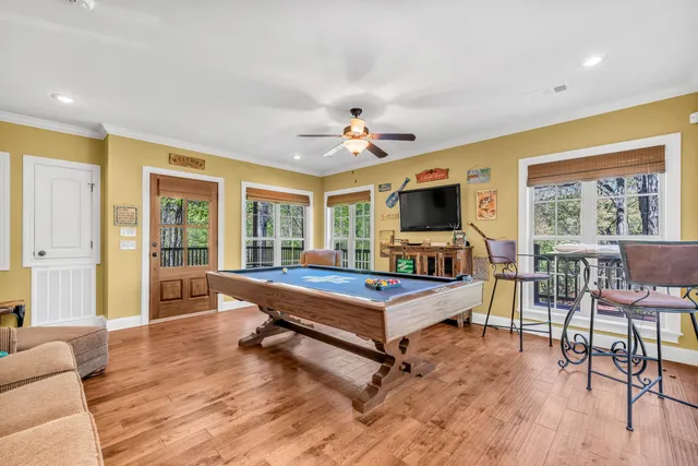 a living room with furniture a flat screen tv and a table
