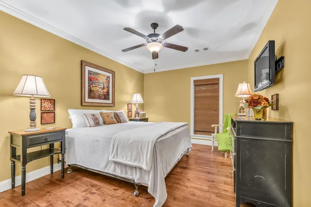 a bedroom with a bed and a chandelier