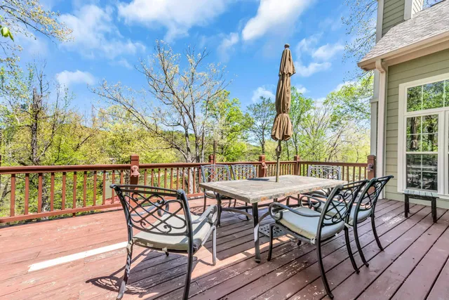 a view of a patio with table and chairs and wooden floor