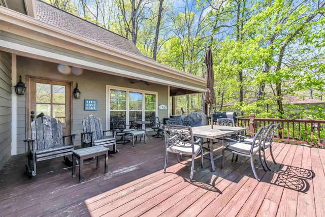 a view of a patio with table and chairs wooden floor and fence
