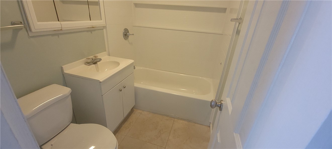 412 7th Road Southwest Vero Beach, FL 32962 - Photo 11 of 19 a white toilet sitting next to a bath tub