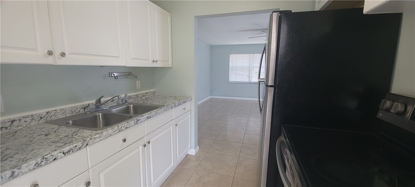 412 7th Road Southwest Vero Beach, FL 32962 - Photo 7 of 19 a kitchen with sink and cabinets