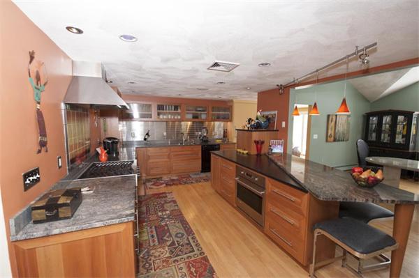 a kitchen with stainless steel appliances granite countertop a sink counter space cabinets and a counter top space