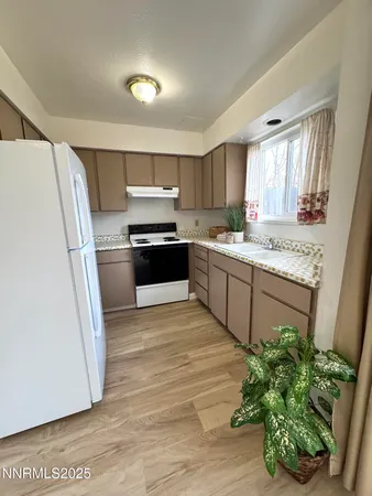 a kitchen with stainless steel appliances granite countertop a refrigerator a sink a stove a microwave a sink and dishwasher