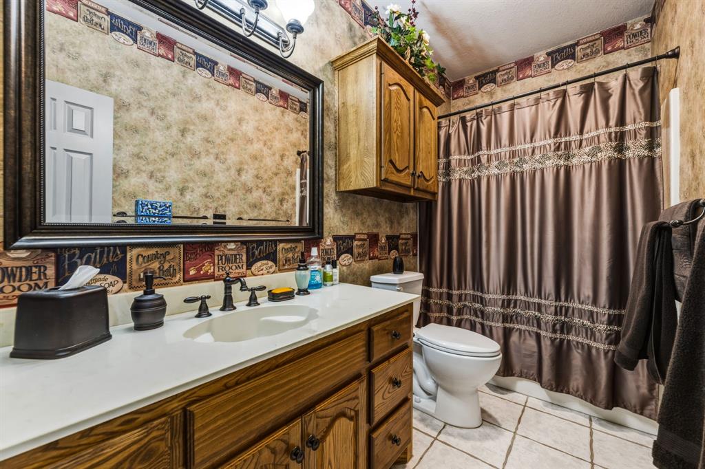 130 Blazek Road Alma, TX 75119 - Photo 26 of 34 a bathroom with a sink a toilet and shower