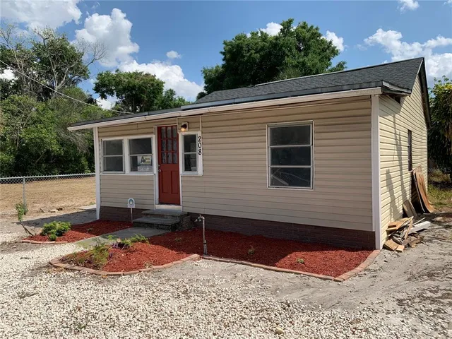 a backyard of a house with yard fire pit barbeque oven and outdoor seating
