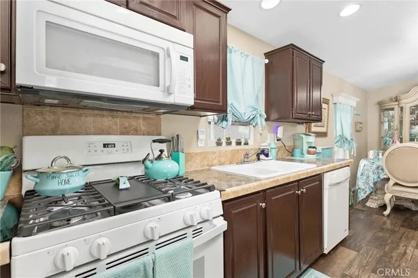 a kitchen with a sink a stove and cabinets