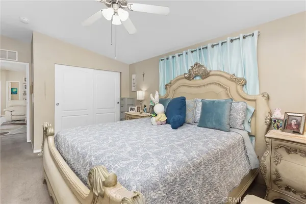 a large bed sitting in a bedroom and table chair